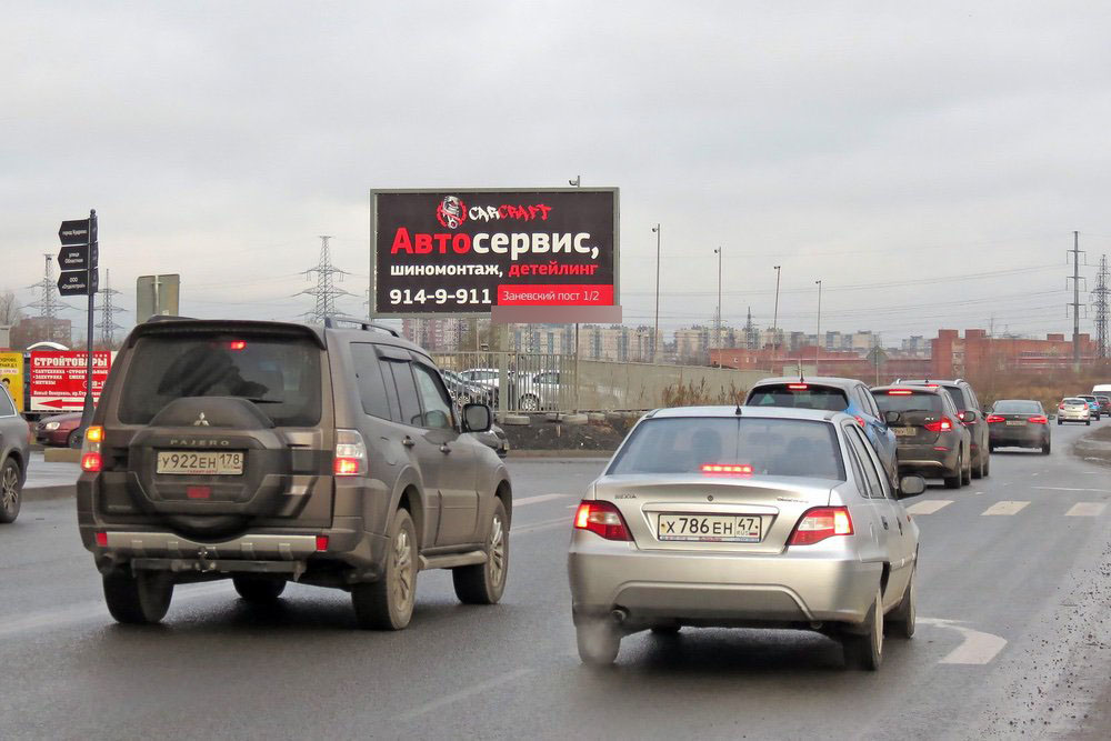 Фотография рекламного носителя, тип: Билборд 3x6, адрес: Строителей пр-т. Х Областная ул., Кудрово, Ленинградская область, Россия. Сторона B №717284