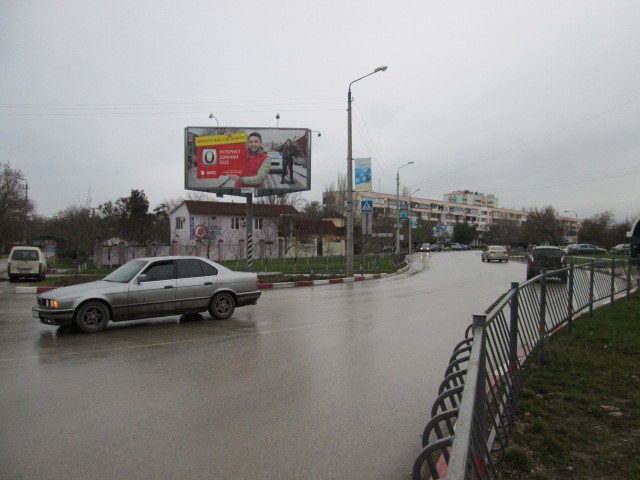 Фотография рекламного носителя, тип: Билборд 3x6, адрес: Чкалова ул. Х Крымская ул., Феодосия, Республика Крым, Россия. Сторона A №411550