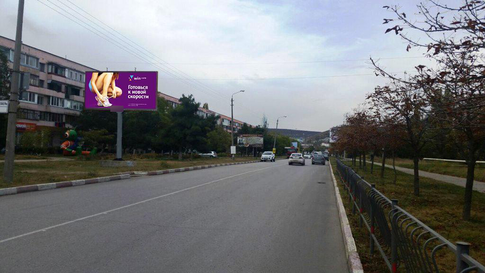 Фотография рекламного носителя, тип: Билборд 3x6, адрес: Крымская ул., д.84, поз.2, Феодосия, Республика Крым, Россия. Сторона B №614090