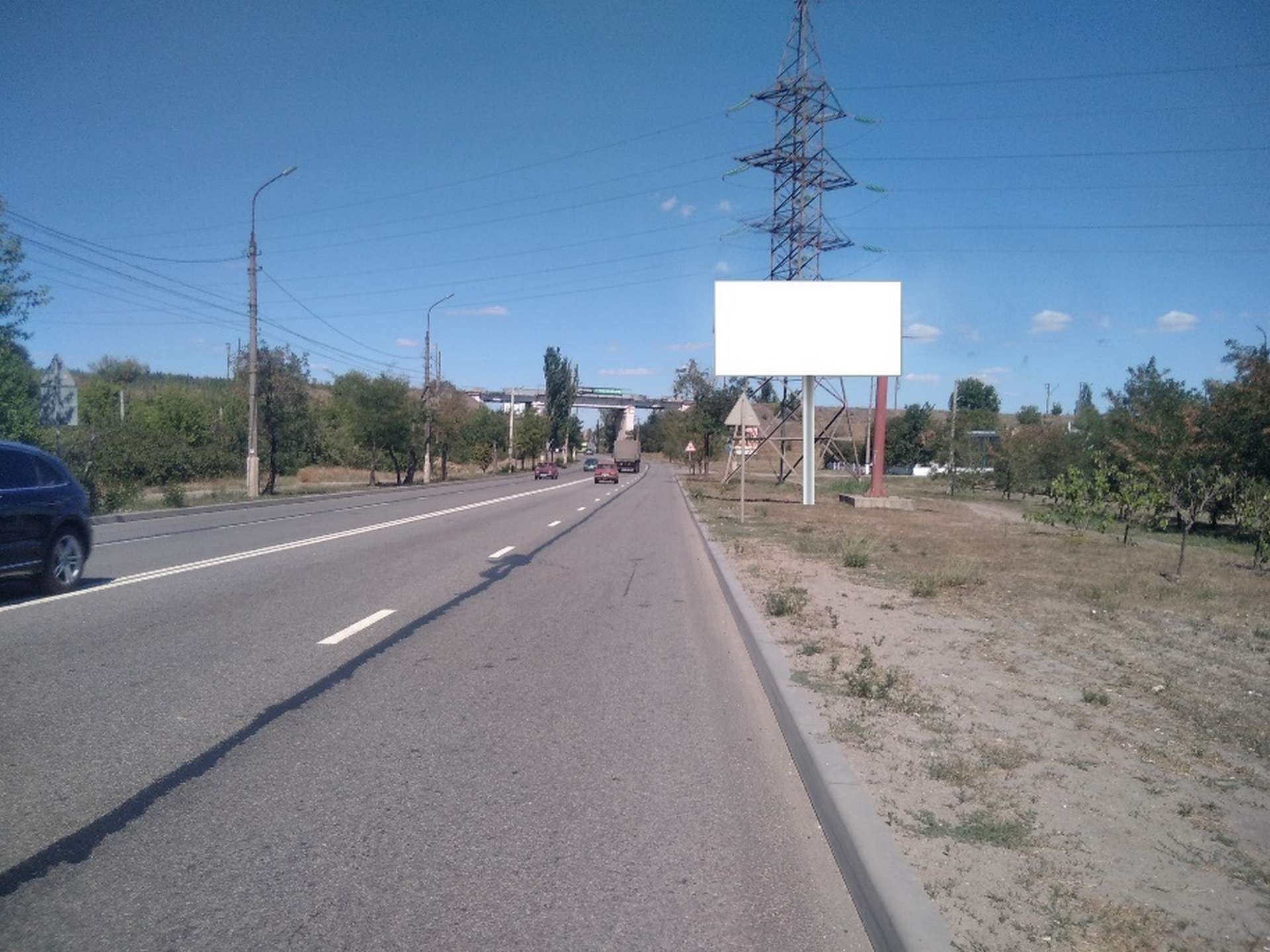 Фотография рекламного носителя, тип: Билборд 3x6, адрес: ул. Заозерная напротив дома 87Б, Мариуполь, Донецкая область, Россия. Сторона А №1372543