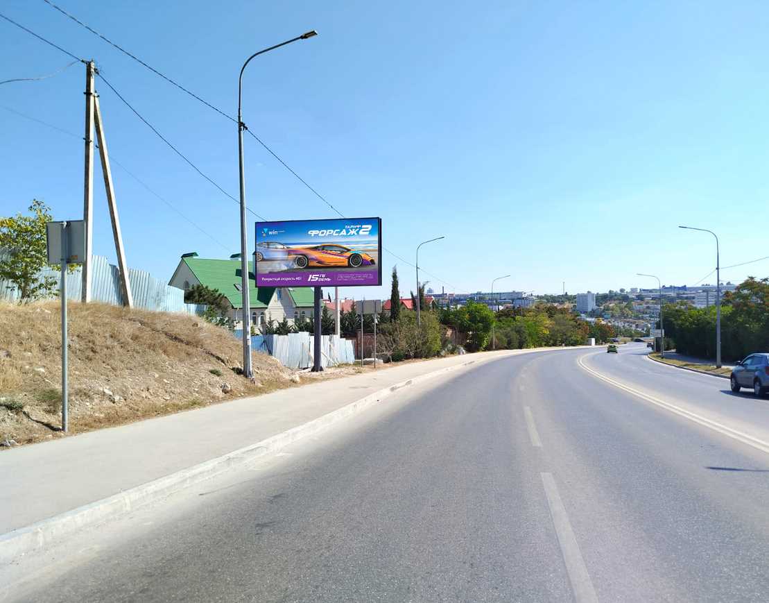 Фотография рекламного носителя, тип: Билборд 3x6, адрес: Александра Маринеско ул. Х Молодых строителей ул., д.25В, Евпатория, Республика Крым, Россия. Сторона B №1377058