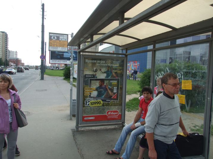 Фотография рекламного носителя, тип: Остановка 1.8x1.2, адрес: Косыгина пр-т., д.26, корп.1, Санкт-Петербург, Россия. Сторона А №130014